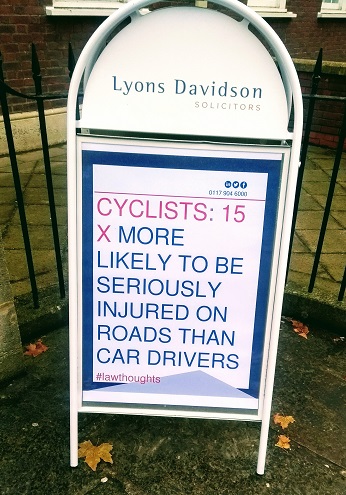 Picture of A-board reading "Cyclists@ 15 x more likely to be seriously injured on the roads than car drivers #lawthoughts" 